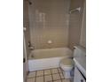 Clean bathroom with tan tile, a bathtub, toilet, and vanity at 303 E Wellington Ct # 59, Tampa, FL 33604