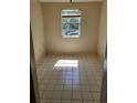 Empty bedroom with tiled floors and a window at 303 E Wellington Ct # 59, Tampa, FL 33604
