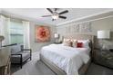 Spacious bedroom with a king-size bed and an accent chair at 17318 Holly Well Ave, Wimauma, FL 33598
