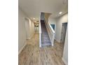 Spacious entryway with wood-look tile and staircase at 16320 Hyde Manor Dr, Tampa, FL 33647
