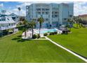 Coastal condo building with pool and lush landscaping at 17980 Gulf Blvd # 205, Redington Shores, FL 33708