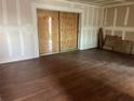 Unfinished bedroom with wood floors and sliding doors at 9027 Westchester Cir # 118, Tampa, FL 33604