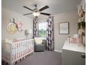 Charming Bedroom featuring a crib, armchair, and decorative wall art at 10378 Honey Hammock Way, San Antonio, FL 33576