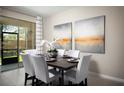 Bright dining room with a dark wood table and white chairs at 10378 Honey Hammock Way, San Antonio, FL 33576