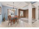 Bright dining area with a four-person table and chandelier at 3001 Silvermill Loop, Land O Lakes, FL 34638