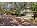 Charming two-story home featuring a two-car garage, and neatly trimmed landscaping at 2839 Bayshore Trails Dr, Tampa, FL 33611
