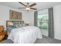 Bright bedroom with a queen-size bed and large window at 11222 Linden Depot Rd, San Antonio, FL 33576