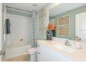 Bathroom with white vanity, tub, and subway tile at 11222 Linden Depot Rd, San Antonio, FL 33576