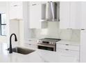 Modern kitchen with stainless steel appliances, white marble-look countertops, and sleek cabinetry at 1218 E Kay St # 10, Tampa, FL 33602