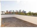 Rooftop deck with wood tiling overlooking a city skyline at 1218 E Kay St # 21, Tampa, FL 33602