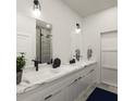 Modern bathroom with double vanity, marble countertop, and walk-in shower at 1218 E Kay St # 26, Tampa, FL 33602