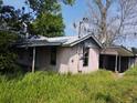 Older home with overgrown vegetation, in need of repairs at 1710 60Th Hwy, Plant City, FL 33567