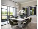 Elegant dining area with a modern table and access to a patio at 32124 Powderpuff Mimosa Dr, San Antonio, FL 33576