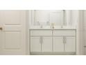 Double vanity bathroom with white cabinets and quartz countertops at 11773 Radiant Shore Loop, San Antonio, FL 33576