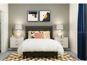 Cozy bedroom with a gray headboard and stylish decor at 12724 Tahitian Pearl Cir, Parrish, FL 34219