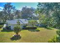 Single-story home with a large yard and mature trees at 12945 Morris Bridge Rd, Thonotosassa, FL 33592