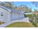 Three-car garage with a spacious driveway at 12945 Morris Bridge Rd, Thonotosassa, FL 33592