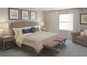 Spacious bedroom with a king-size bed and sitting area at 6538 Back Forty Loop, Zephyrhills, FL 33541