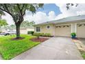 Exterior view of villa, showcasing landscaping and driveway at 34903 Double Eagle Ct, Zephyrhills, FL 33541