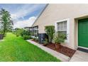 Side view of villa showcasing exterior and green space at 34903 Double Eagle Ct, Zephyrhills, FL 33541