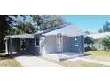 Newly renovated home with carport and front porch at 10008 N Jasmine Ave, Tampa, FL 33612