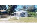 Newly painted house with a fenced yard and walkway at 10008 N Jasmine Ave, Tampa, FL 33612