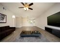Bright living room with hardwood floors, a large TV, and comfortable seating at 2431 Franciscan Dr # 49, Clearwater, FL 33763