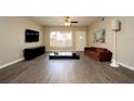 Living room features hardwood floors, a large TV, and stylish furniture at 2431 Franciscan Dr # 49, Clearwater, FL 33763