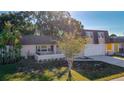Exterior view of a two-story home with a brown roof and a two-car garage at 3604 Rockaway Dr, Holiday, FL 34691