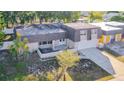 Aerial view of a house with a large yard, showing neighboring houses and a lake at 3604 Rockaway Dr, Holiday, FL 34691