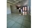 Bright living room with tile floors and access to the kitchen at 7513 Robindale Rd, Tampa, FL 33619
