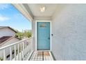 Front entrance with light blue door and small balcony at 1013 Apollo Beach Blvd # 202, Apollo Beach, FL 33572