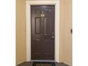 Image of a dark brown apartment entrance door with number 302 at 5125 Palm Springs Blvd # 9302, Tampa, FL 33647