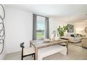 Dining area with light wood table, bench, and gray curtains at 2530 Leonia Ln, Zephyrhills, FL 33541
