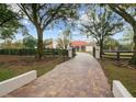 Long paver driveway leading to a luxury estate at 11623 Innfields Dr, Odessa, FL 33556