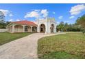 Home exterior showcasing a red tile roof and a large lawn at 11623 Innfields Dr, Odessa, FL 33556