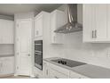Modern kitchen with stainless steel appliances and white cabinets at 11217 Livewell Ct, Venice, FL 34293