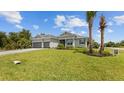 Two-story house with gray siding, paver driveway, and landscaped lawn at 14350 Allensworth Ave, Port Charlotte, FL 33981