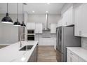 Bright kitchen with white cabinets, stainless steel appliances, and an island at 17059 Nokota Ave, Hudson, FL 34667