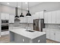 Modern kitchen featuring stainless steel appliances and a large island at 17059 Nokota Ave, Hudson, FL 34667