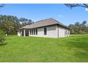 Large backyard with covered patio and outdoor kitchen at 17059 Nokota Ave, Hudson, FL 34667