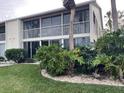 Condo building with balconies and tropical landscaping at 201 Silver Lake Dr # 101, Venice, FL 34292