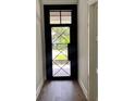 Stylish front door with a detailed iron design and transom window at 3109 W Knights Ave, Tampa, FL 33611