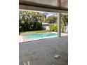 Inviting backyard pool and spa with surrounding landscaping and travertine deck at 3109 W Knights Ave, Tampa, FL 33611
