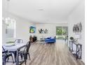 Open living room and dining area with hardwood floors and sliding glass doors leading to the backyard at 2437 Orange Harvest Pl, Seffner, FL 33584