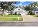 Two-story house with attached garage and a well-maintained lawn at 2927 Minuteman Ln, Brandon, FL 33511