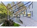 Inviting screened pool and patio area overlooking the lake at 806 Taray De Avila, Tampa, FL 33613