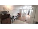 Bright kitchen with microwave and access to dining area at 4851 W Gandy Blvd # B4 L32, Tampa, FL 33611