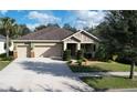 Single-Gathering home with a three-car garage and manicured lawn at 903 Heritage Groves Dr, Brandon, FL 33510