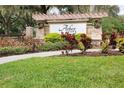 Arbor Oaks community entrance with stonework and festive wreaths at 903 Heritage Groves Dr, Brandon, FL 33510